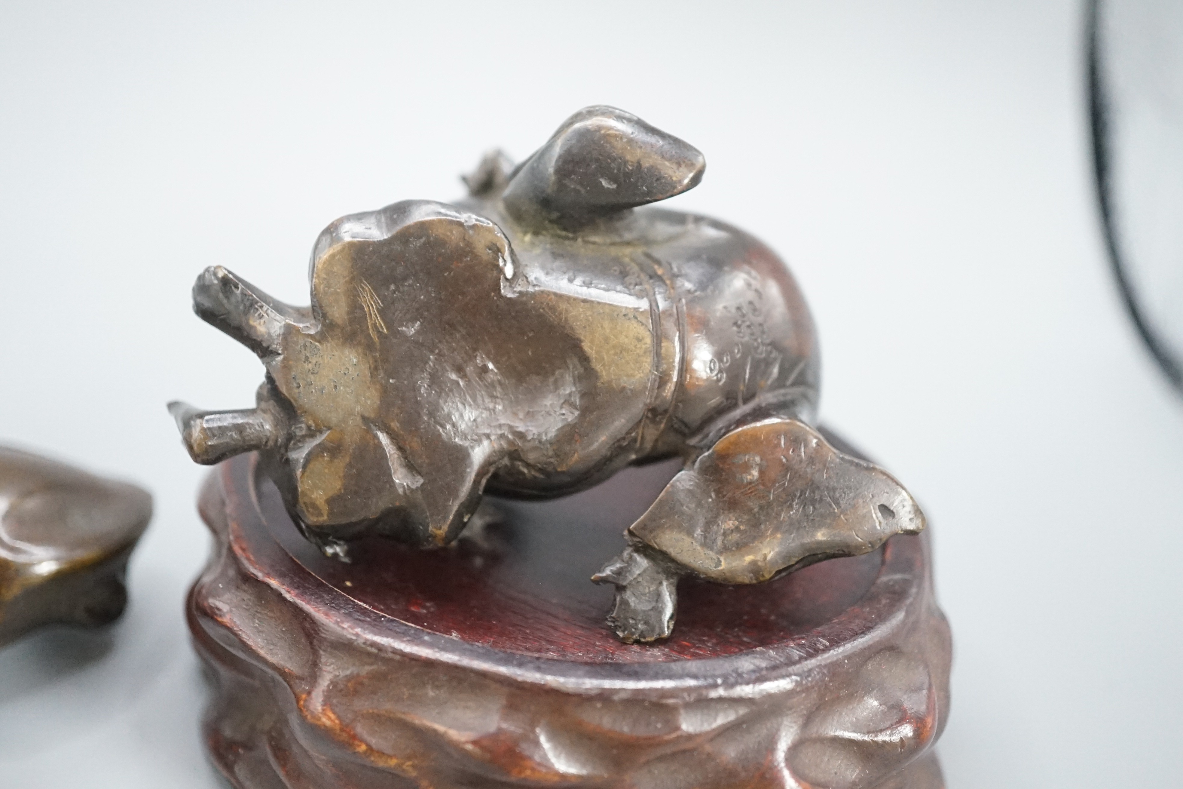 A Chinese bronze group of Liu Hai and a toad, wood stand and a bronze figure of a dog, 9cm
